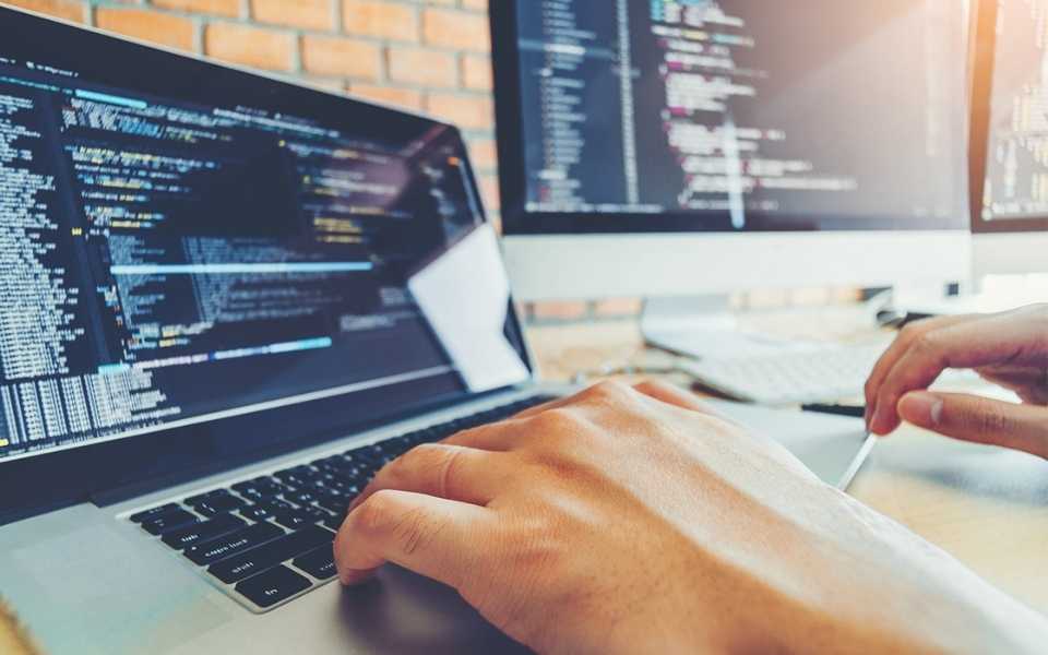 A person works on programming sites for web design and coding. Concept of software localisation.