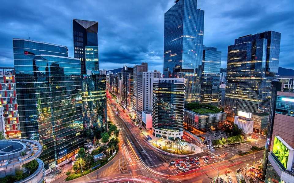 Downtown view at night of Gangnam Square in Korea. Concept of English to Korean translation.