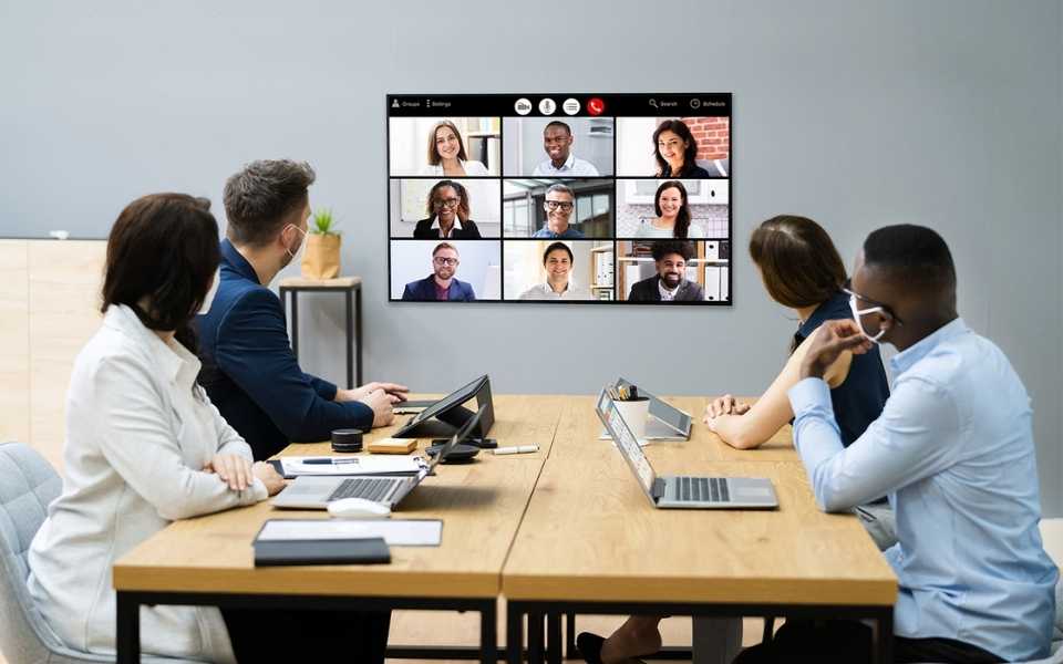 Two men and two women having room meeting in an office. Concept of professional translation.