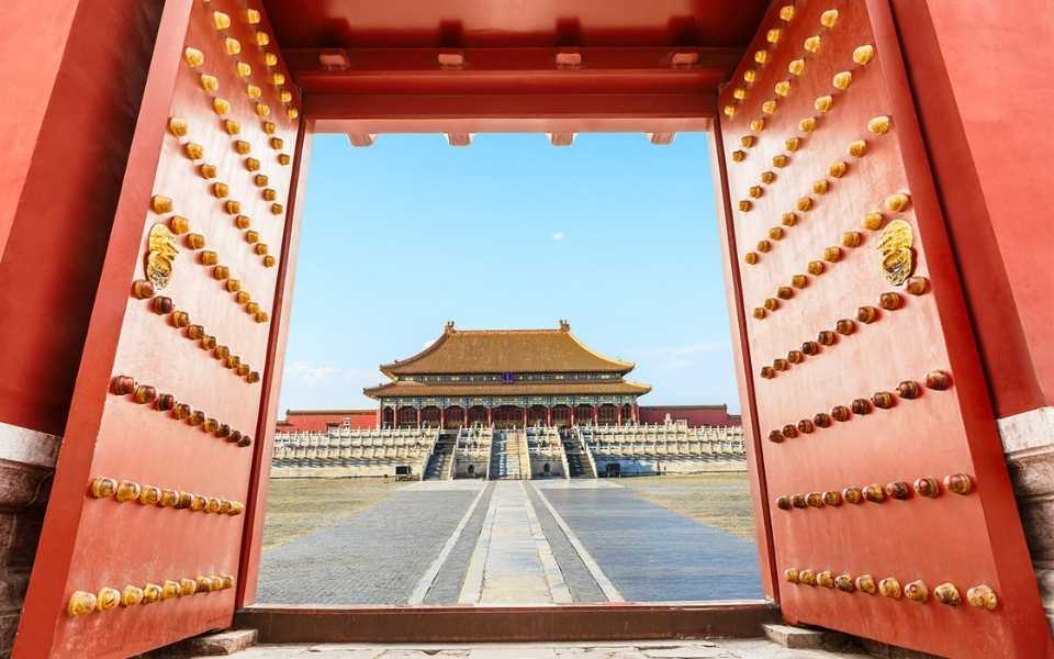 A great red gate of an ancient Chinese palace in Beijing, China. Concept of Chinese translation service.