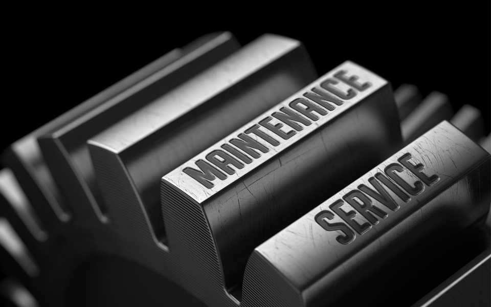 Metal gear, black background, "Maintenance Service" written on the gear. Concept of technical document translation.