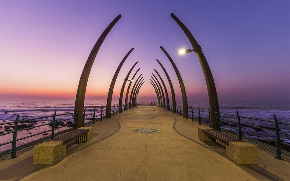 A passage on the sea at a violet sunset in South Africa. Concept of English to Afrikaans translation.