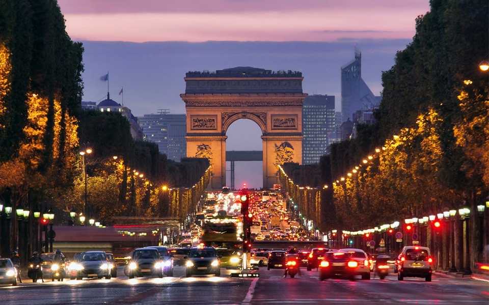 The Champs-Elysees in Paris at sunset, with cars on the way. Concept of English to French translators.