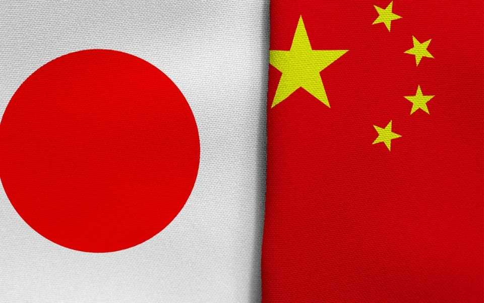 Japanese and Chinese flags overlapping each other.