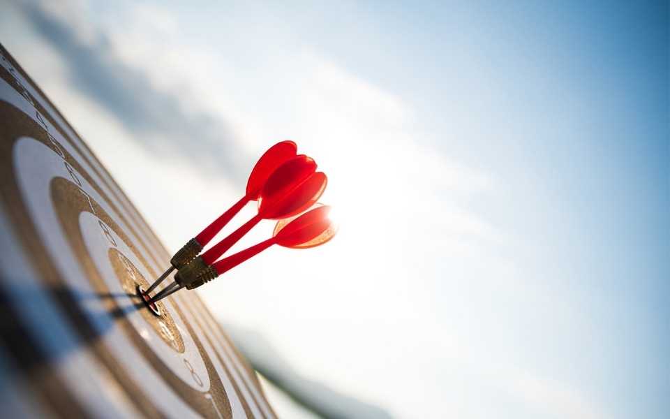 Close-up of red arrows in the bullseye of a target. Concept of accuracy of document translation and using the best translators.