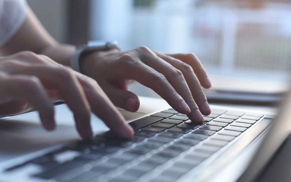 Hands typing on keyboard. Concept of accurate translation and free machine translator.