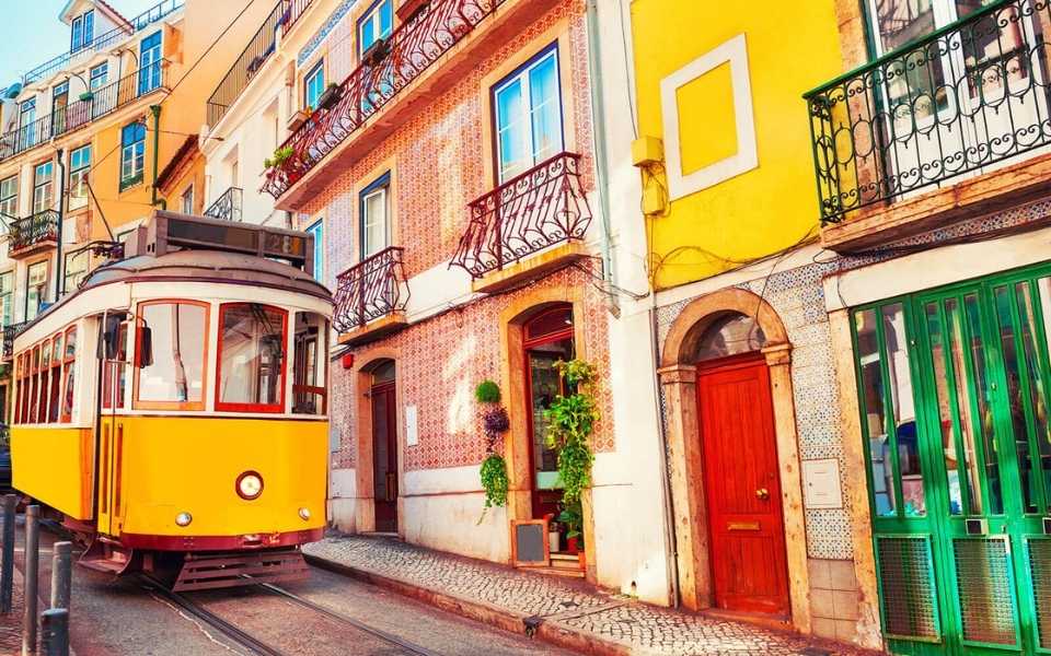 A yellow train in the city centre of Lisbon, Portugal. 
