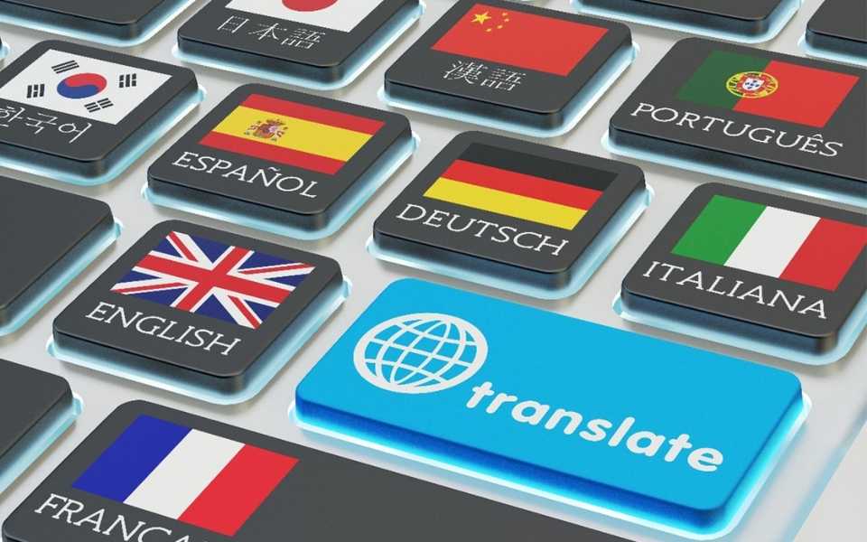 Keyboard with flags and languages of countries and a button saying “Translate”. Concept of professional translation services.