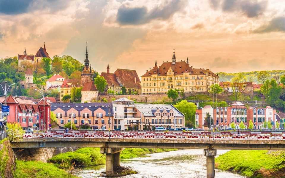 Sighisoara fortress, in the beautiful sunset hours in Transylvania, Romania. Concept of English to Romanian translation.