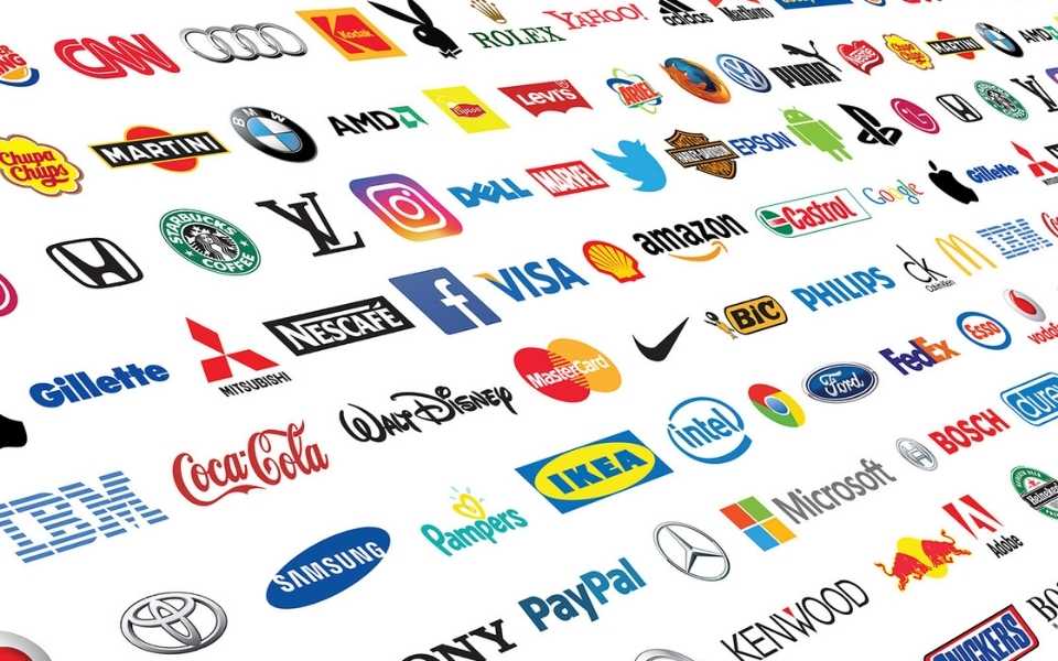 Collection of logos of global brands printed on paper. Concept of brand naming and brand translation.