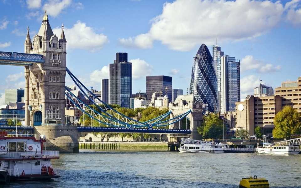 The Tower Bridge and some beautiful buildings in the city of London. Concept of translated languages in London.