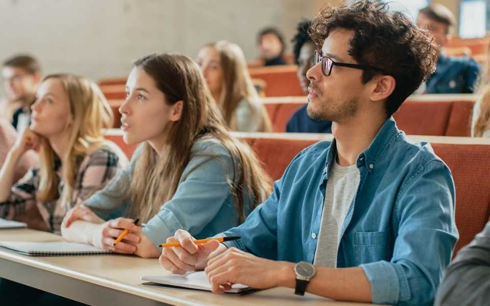 Students focused in their lecture and looking directly at the lecturer. Concept of Academic translations.