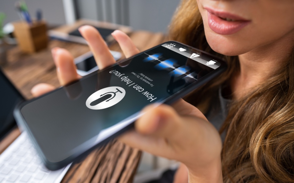 A professional woman using voice assistant for mobile. Ai for voice over generation. 