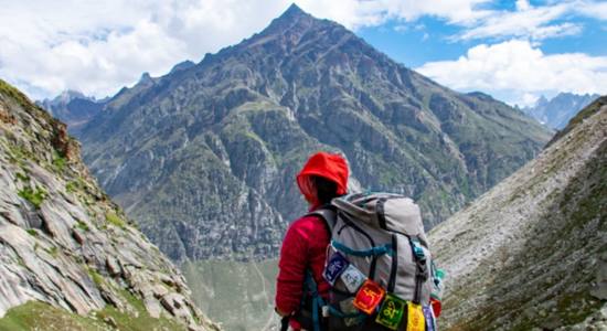 A local tourist visiting Hampta Pass Trek Himachal Pradesh a Sanskrit mantra. Concept of a Sanskrit translator.