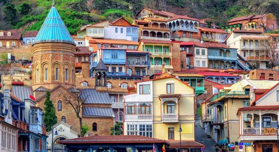 View of colourful traditional building in an old two in Tbilisi, Georgia. Concept of English to Georgian translation services.