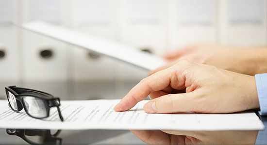 Man hand pointing to paper on table. Concept of medical Czech translation.
