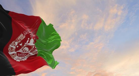 The black, red and green flag of Afghanistan. Concept of Dari translation services.