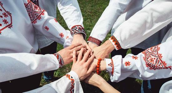 8 arms reaching inwards to put their hands together. Concept of professional Ukrainian translators. 