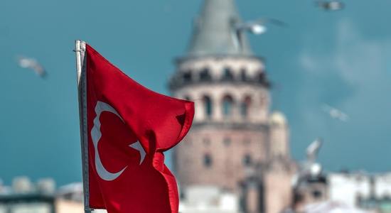 View of Galata Tower and the Turkish flag. Concept of Turkish translation services. 