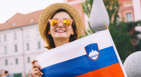 Slovenian woman holding the flag of Slovenia. Concept of Slovenian language translator. 