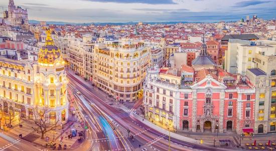 Evening view of the historic Gran Vía street in Madrid, Spain. Concept of Spanish translation services.