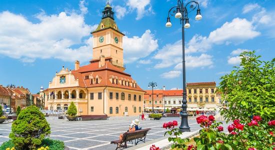 Casa Sfatului, a historical cream and yellow town hall building in Brașov.