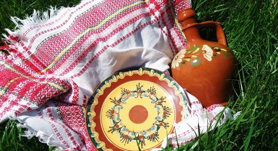 Bulgarian traditional pottery, jug and plate with traditional ornaments tablecloth.