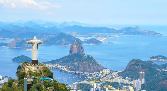 Aerial view of Rio de Janeiro city with Corcovado Mountain and Christ Redeemer. Concept of translating English to Portuguese. 