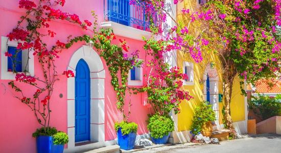 A street with colourful Greek houses and flowers in Kefalonia.