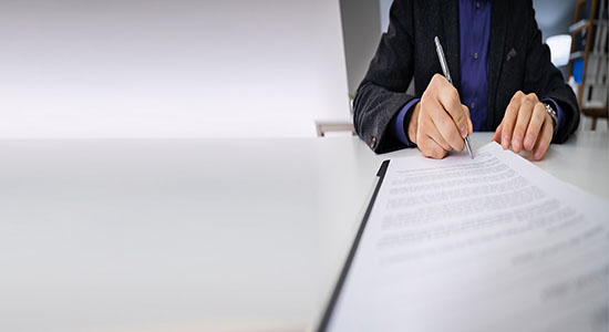Professional man signing a contract. Concept of legal Japanese translation.