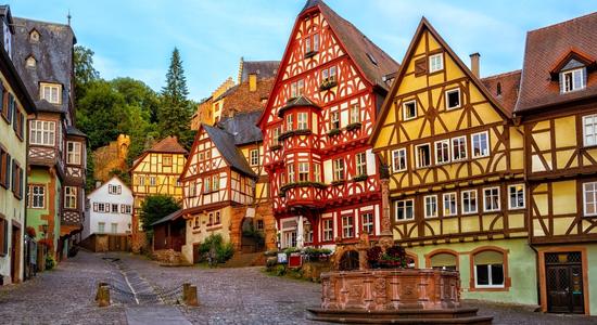 Colourful timbered houses in a street in Miltenberg, Bavaria, Germany. Concept of English to German translation.