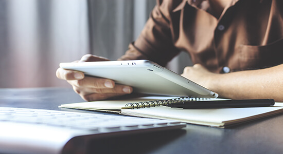 A businessman working with tablet. Concept of technical Swedish translation.