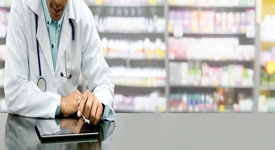 Male pharmacist working in a drug store.