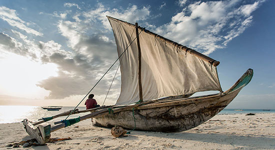 Dhow on beach of Zanzibar Island in Tanzania.. Concept of Swahili translation services.