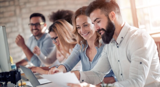 Businesspeople collaborating in an office. A concept of Albanian document translation services company.
