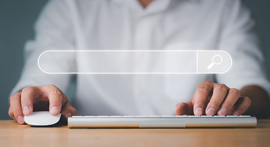Man using keyboard and mouse for search. 