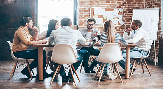A group of professionals meeting as a team in office. Concept of manufacturing translation services. 