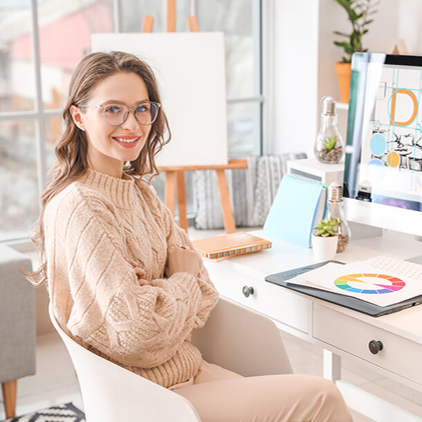 A professional smiling businesswoman standing in office with folded hands.