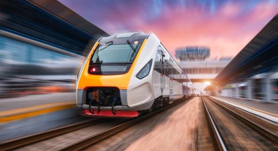 Long exposure image of a bullet train in a station at sunset.