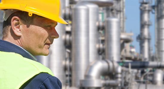 The side profile of an engineer squinting at a construction site. Concept of chemical engineering translation.
