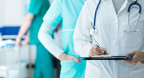 Medical staff including doctor and nurses working at hospital.