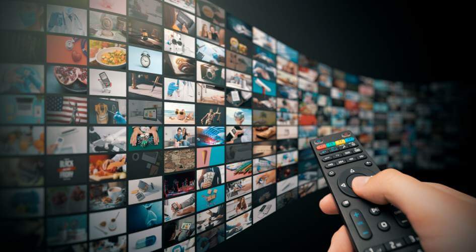 TV video streaming concept. Media TV, video on demand technology with remote controller in hand. A concept of video subtitling services. 